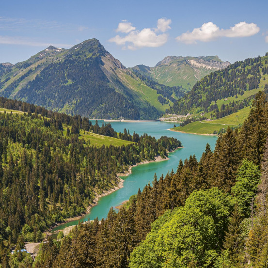 A beautiful view of a lake surrounded by mountains in Longrin lake and dam Switzerland, Swissalps